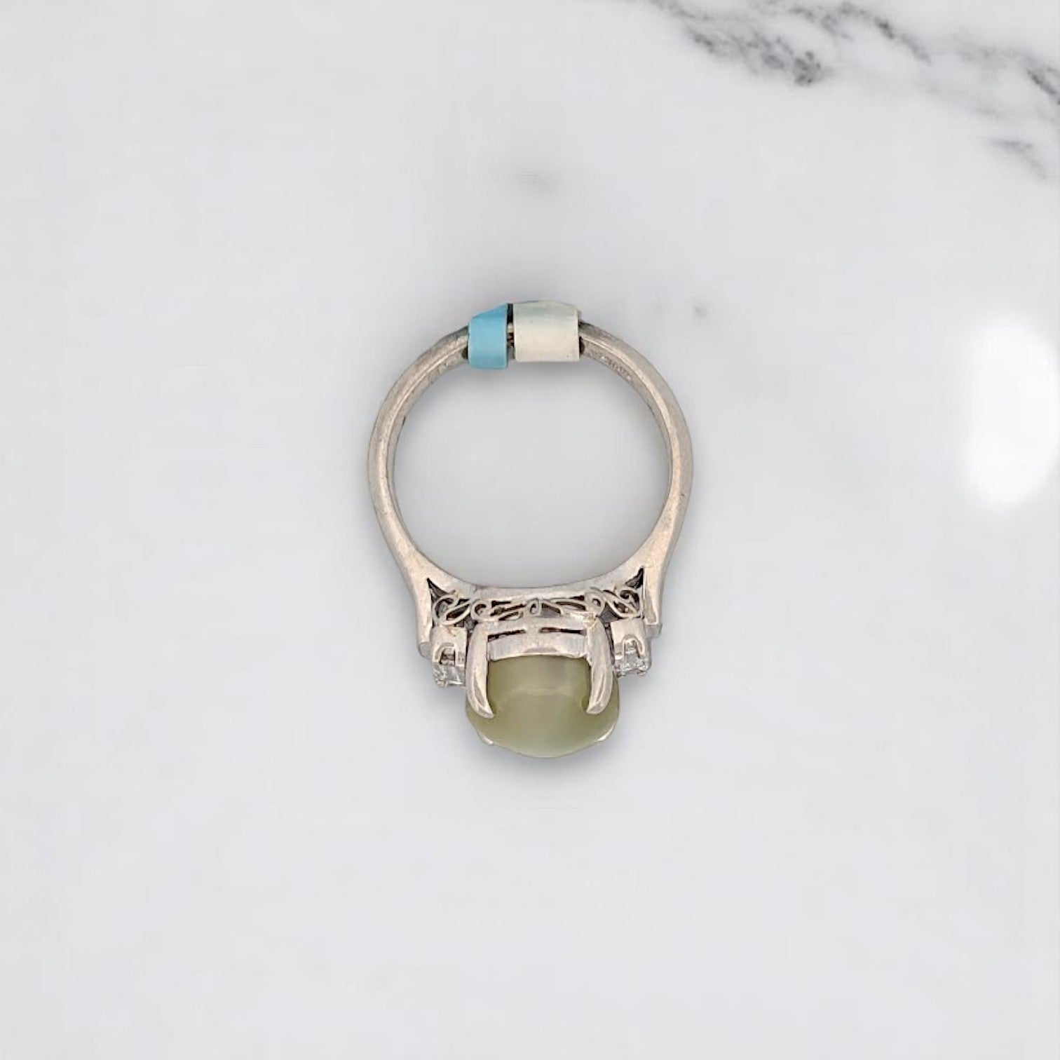Platinum ring featuring a prominent cat's eye chrysoberyl gemstone flanked by natural diamonds, ideal for luxury engagement.