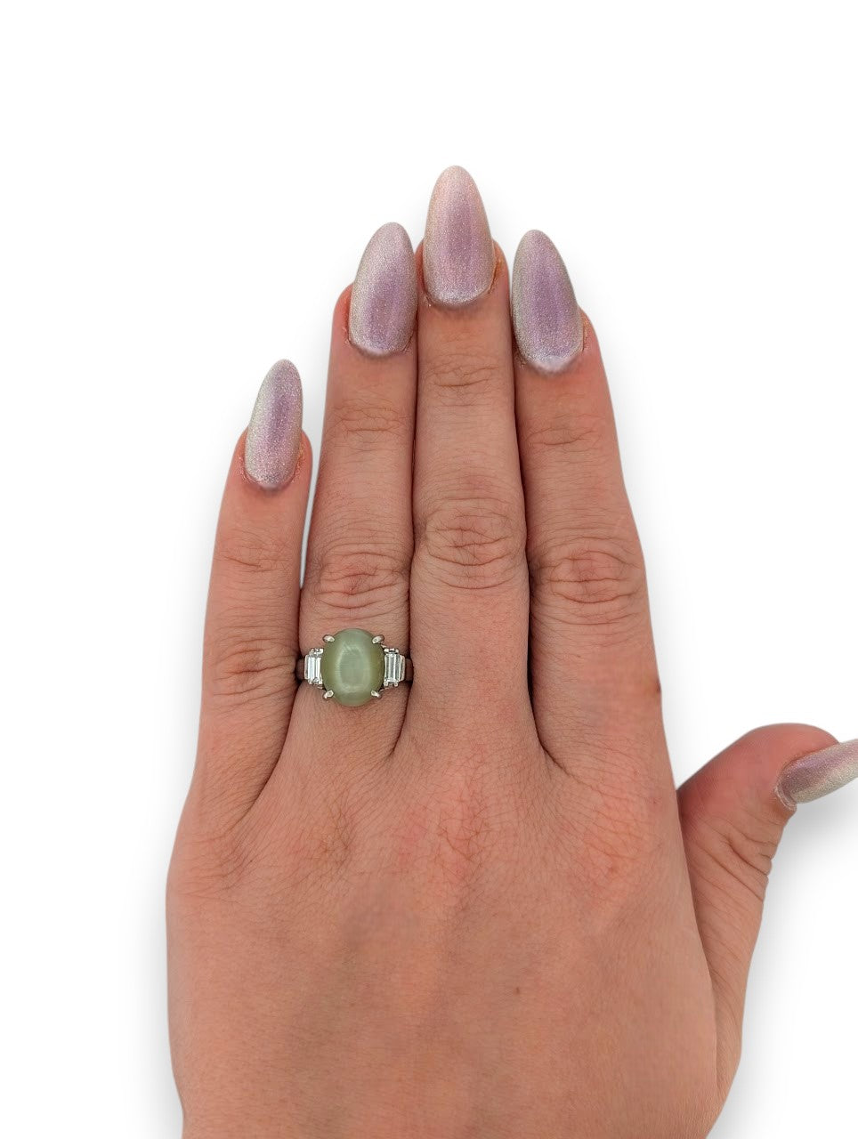 Exquisite platinum engagement ring showcasing a captivating cat's eye chrysoberyl as the center stone, beautifully accented with sparkling natural diamonds.