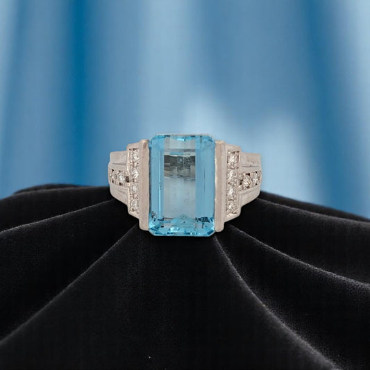Platinum ring with 7.73 ct emerald cut center stone and natural diamonds